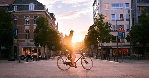 Belgium sunset with bike rider in street