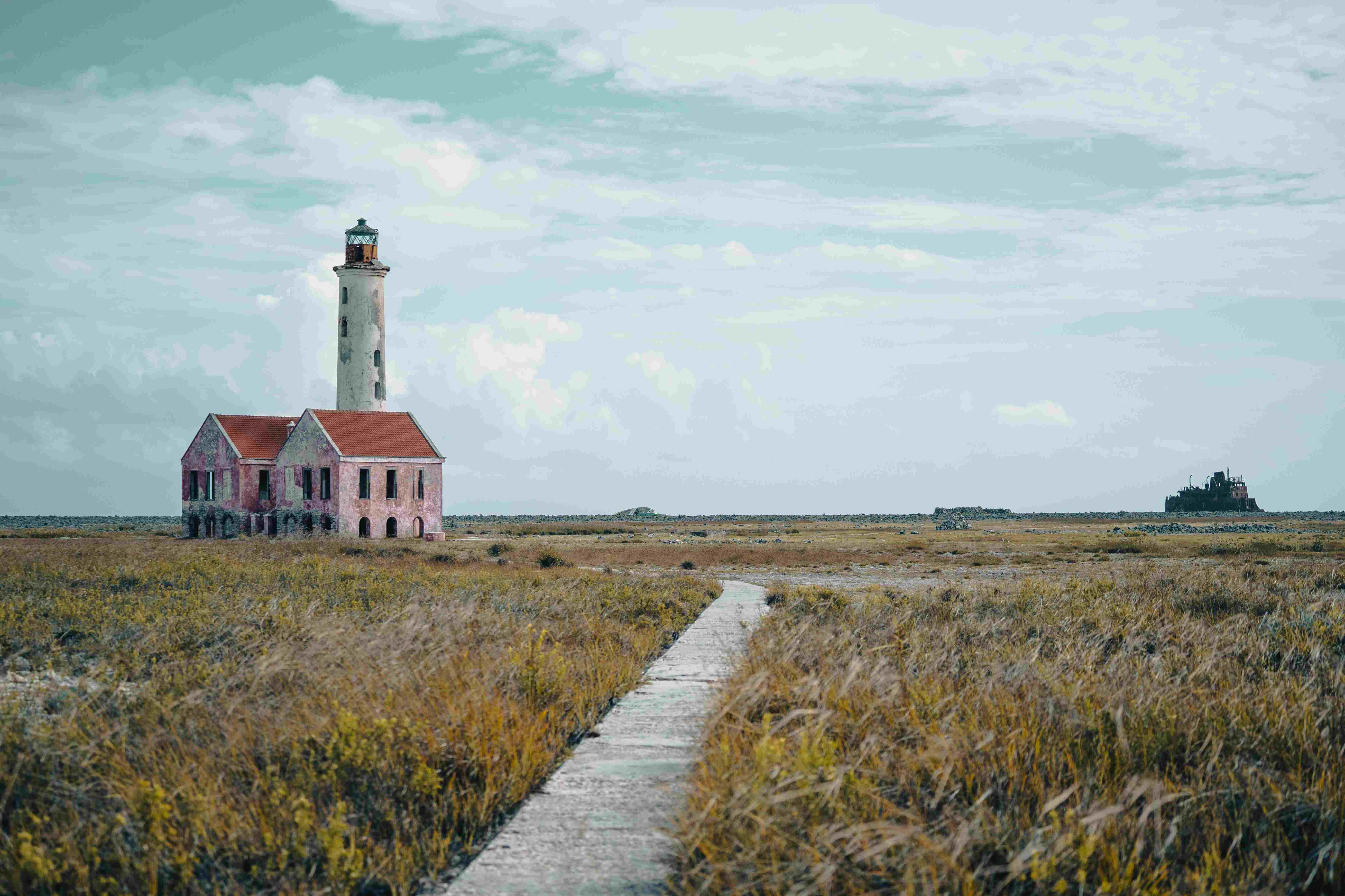 secluded lighthouse in a field of grass