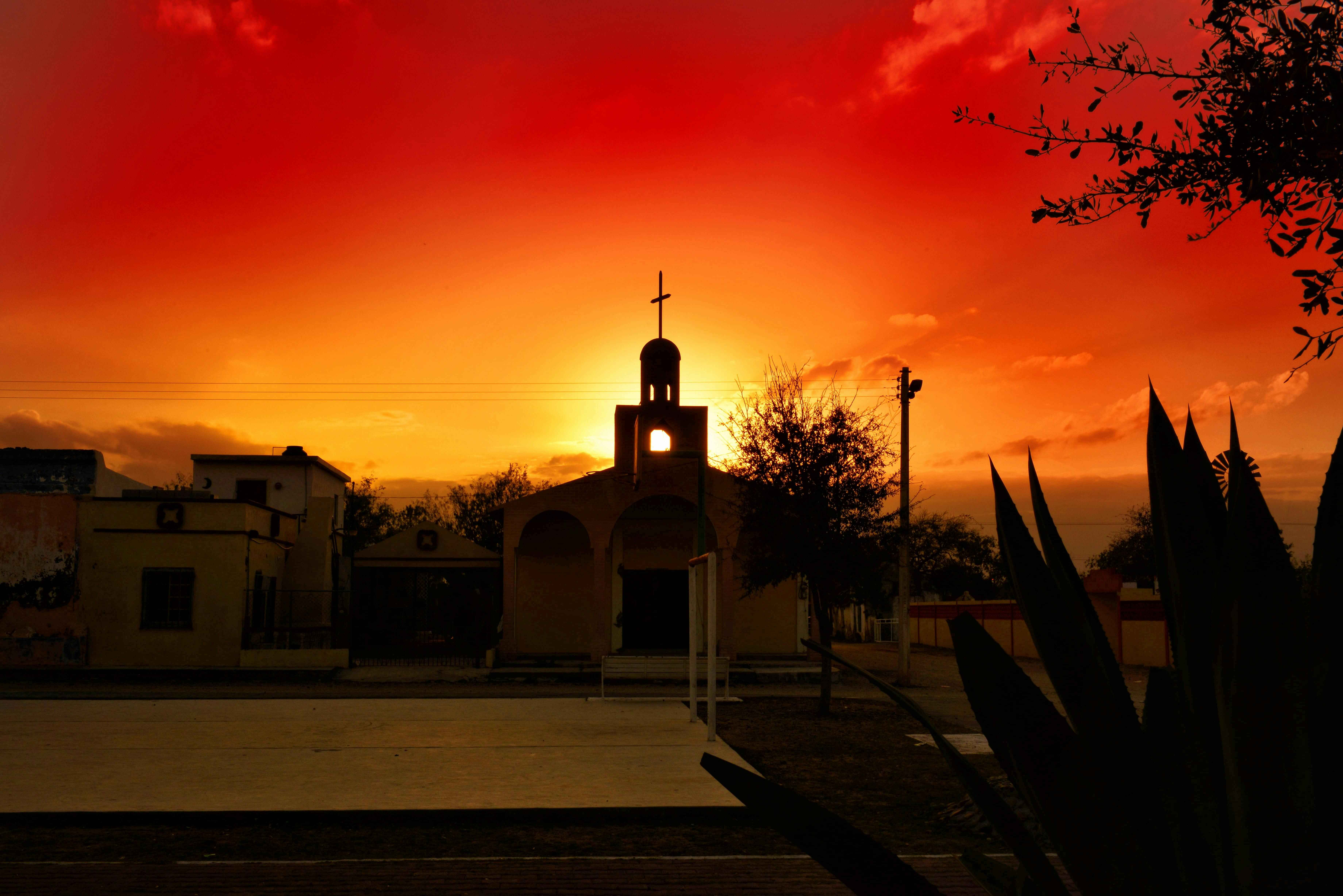 sunset over a church in mexico