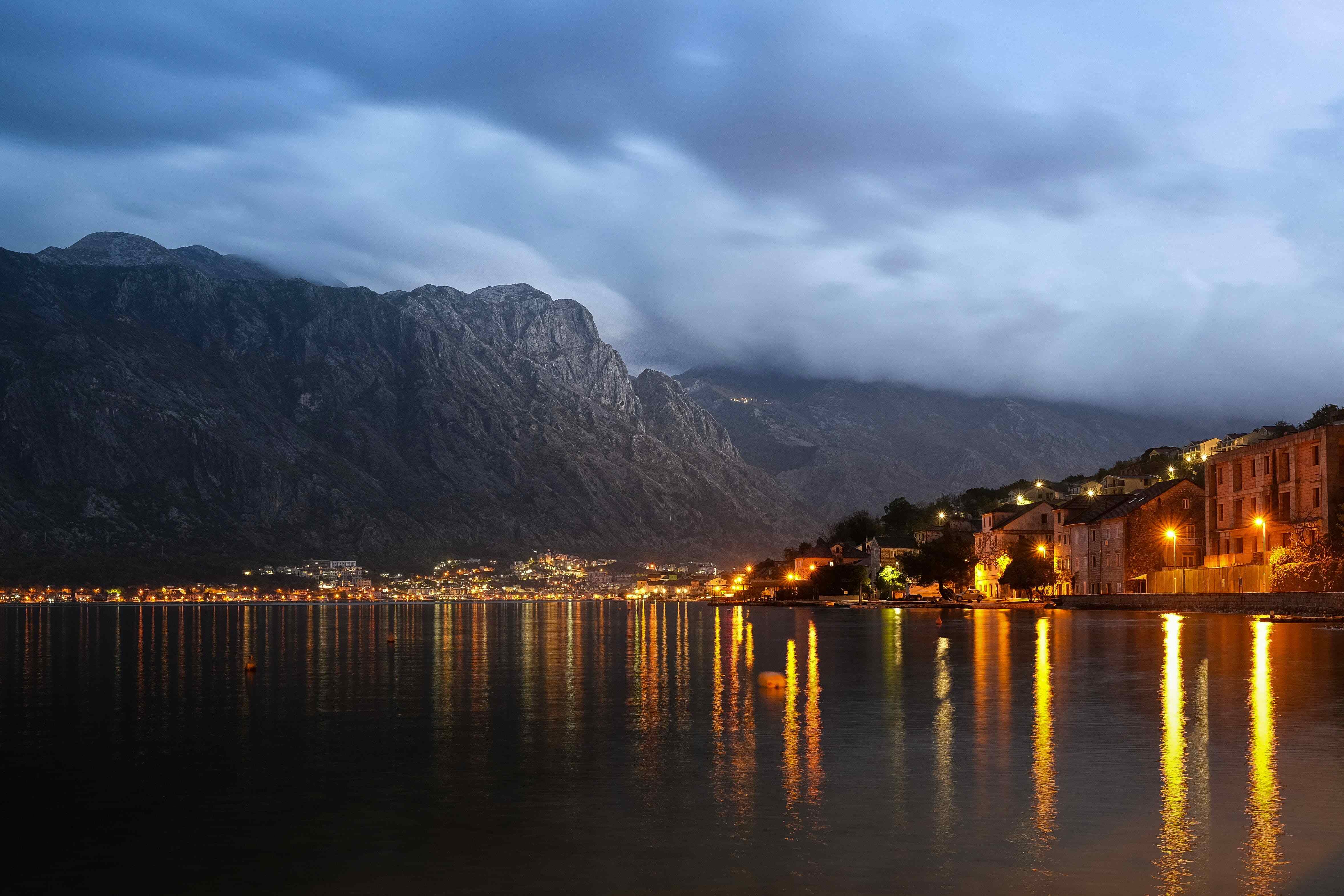 Lights on a city reflecting with a mountain