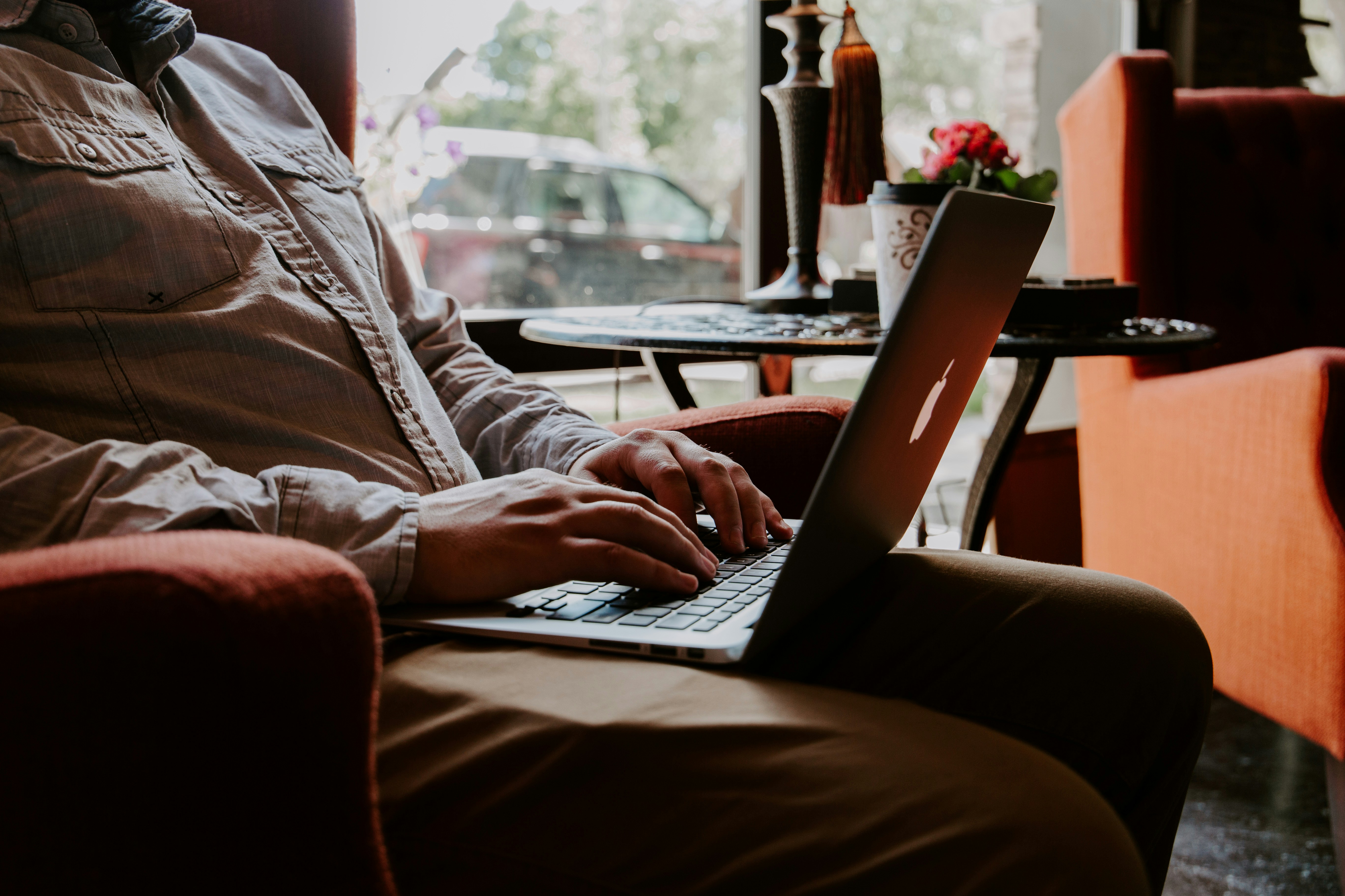 A man is typing on a laptop