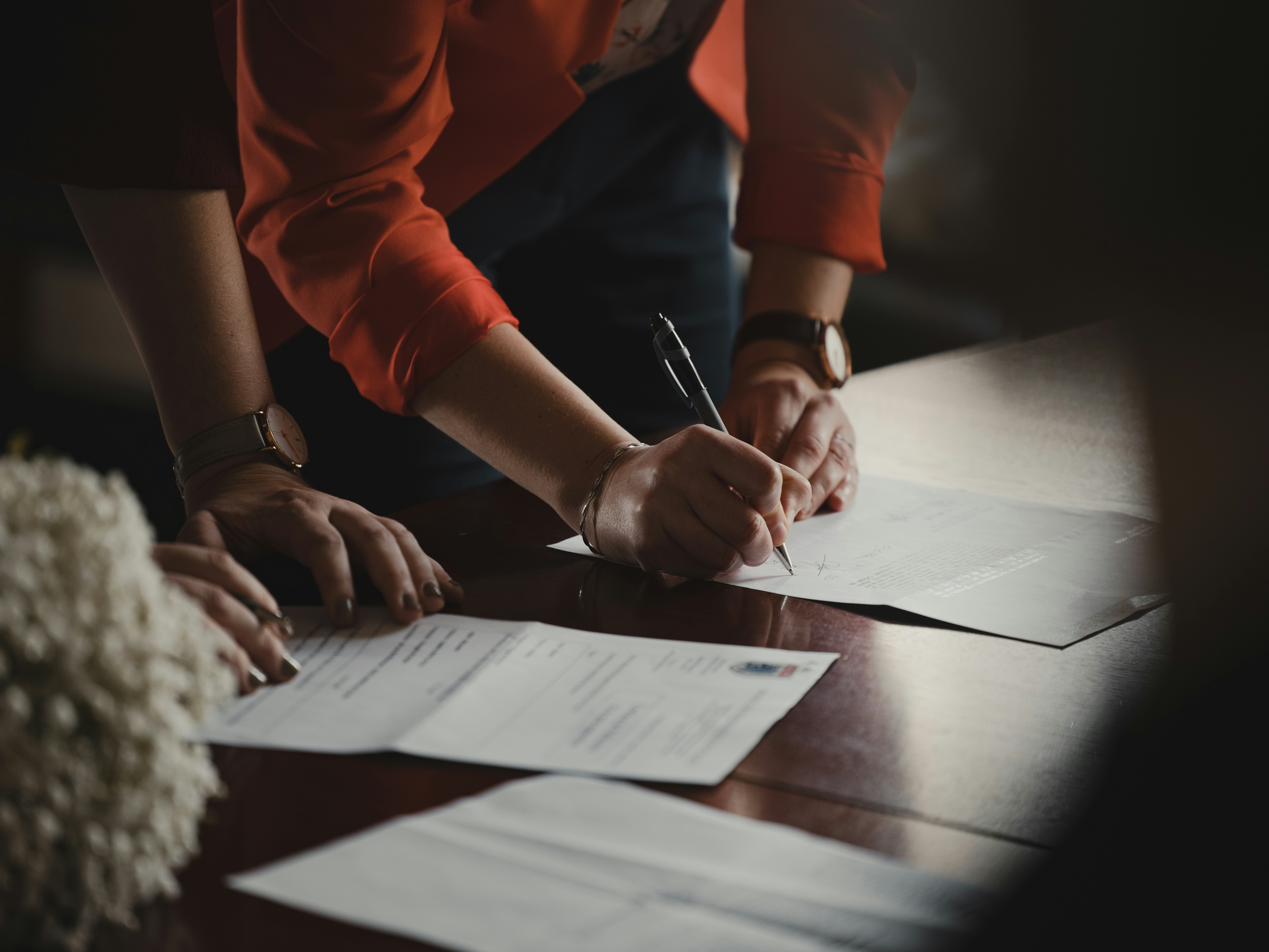 People signing documents