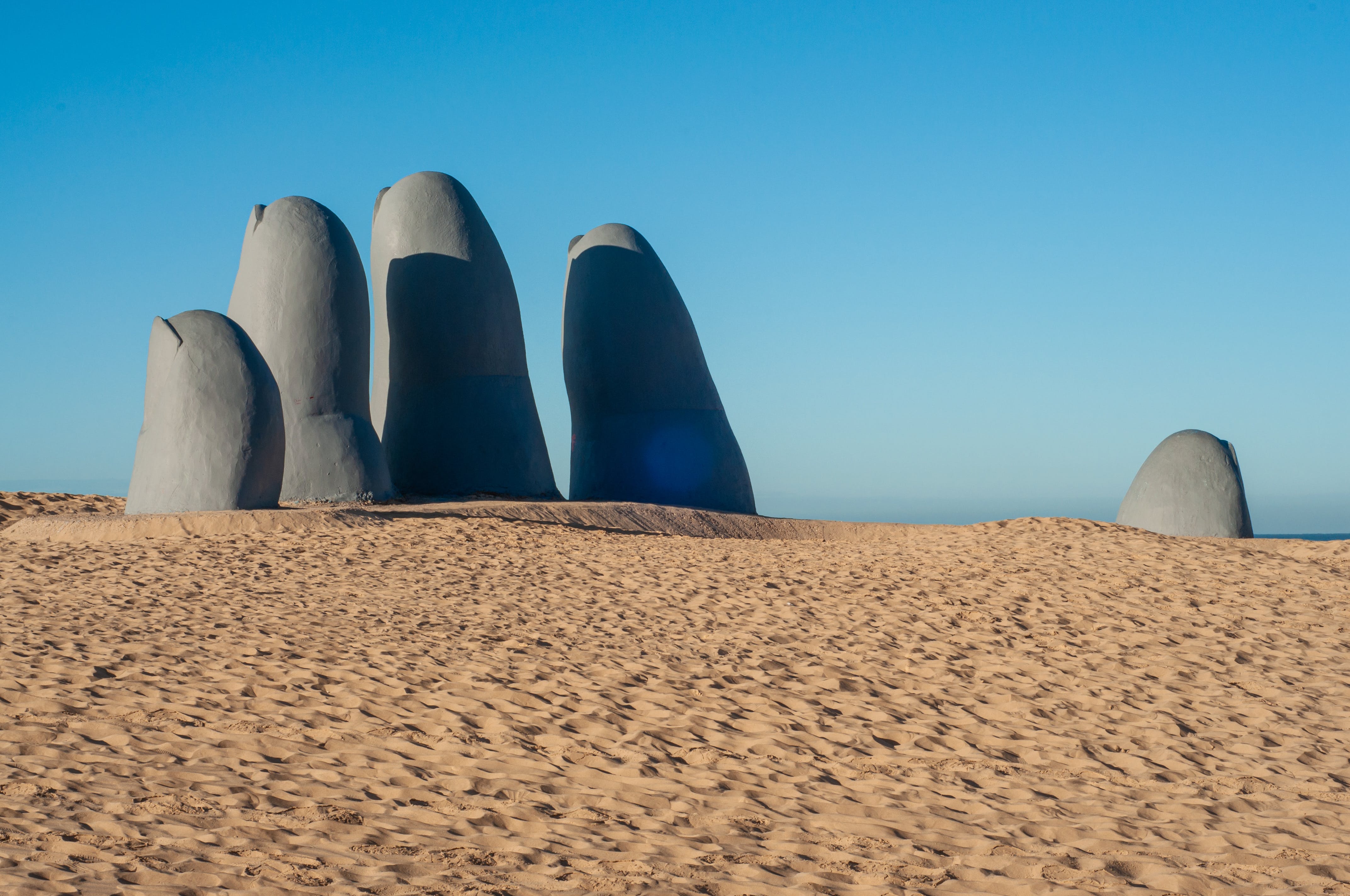 Huge hand sculpture inside the sand