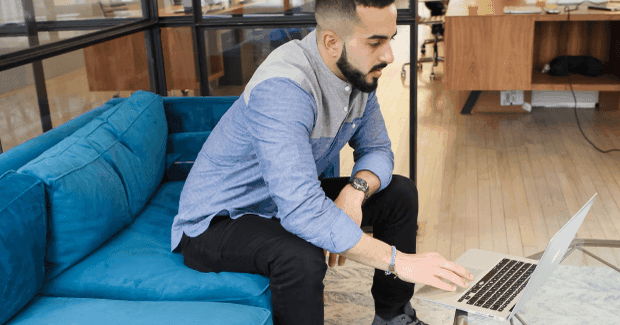 Man with laptop on a couch