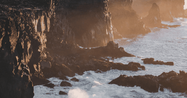 foamy waters crashing along cliffside